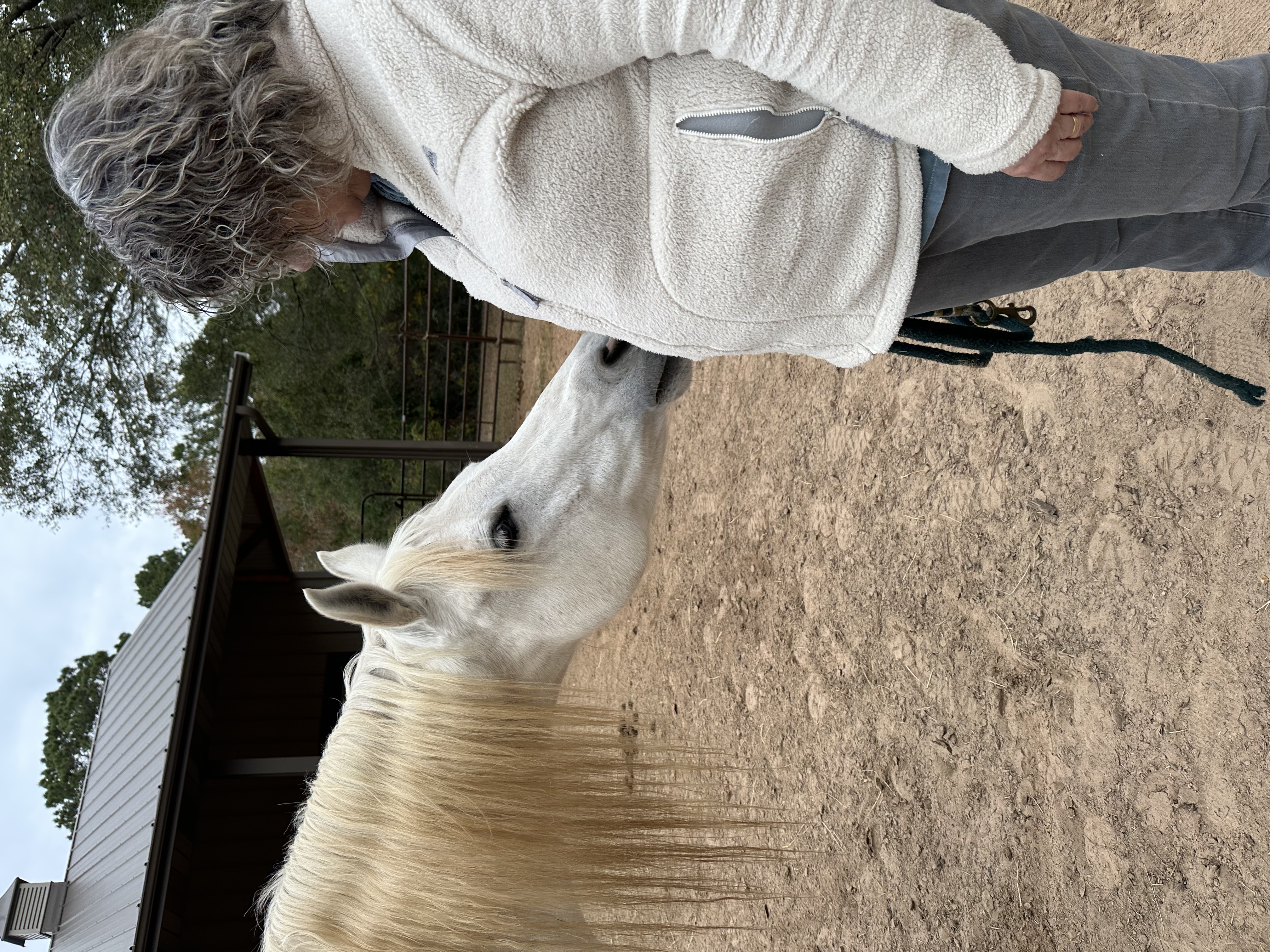 Lizette nuzzling a white horse